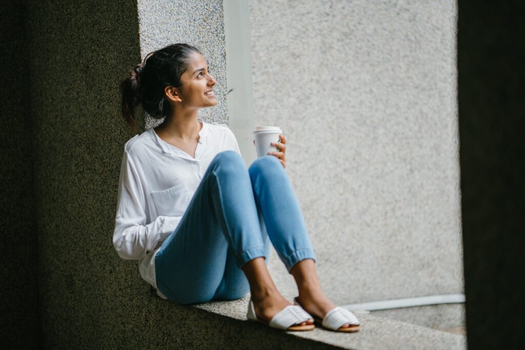 woman sitting and holdging a cup of coffee