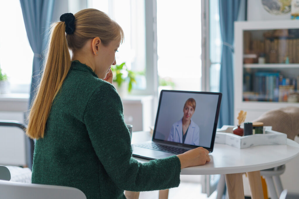 woman videocalling doctor online from home telemedicine