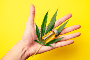 male hand holding cannabis oil in the vials