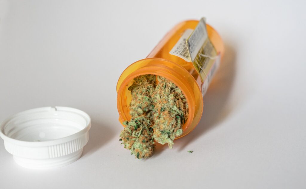 Medical marijuana close up spilling out of a prescription bottle