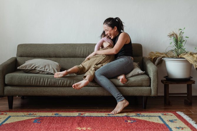 Happy mother who has received relief from the discomfort of bloating and gas using CBD