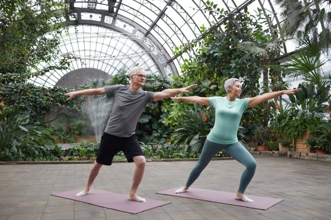 Happy couple performing yoga pose without fear of seizure thanks to medical cannabis